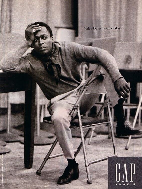 Gap Who Wore Khakis advertisement showing Miles Davis leaning forward in a chair beside a table.