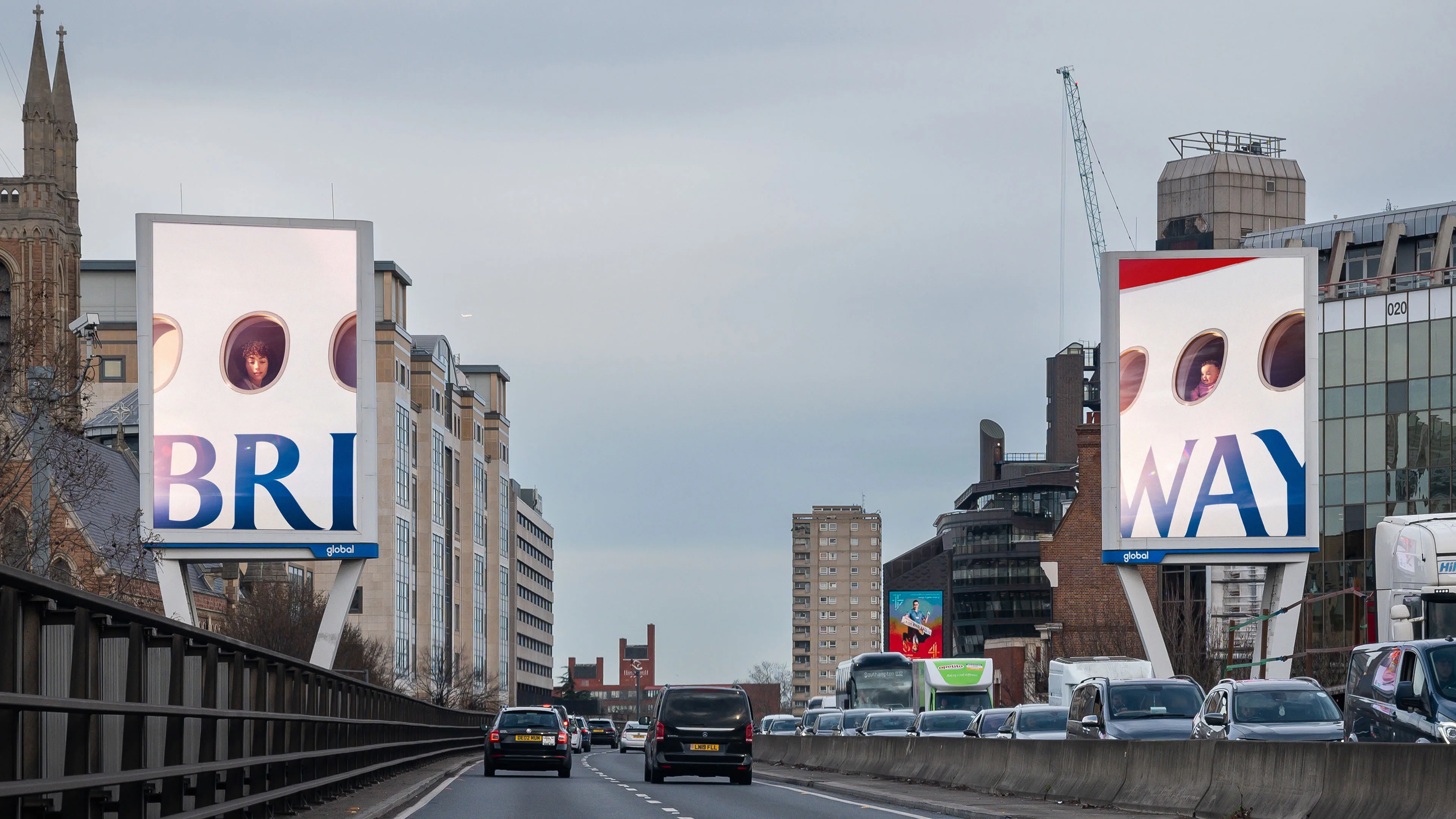 Two roadside British Airways billboards split the cropped wordmark into BRIT and WAY while different passengers look from the aircraft windows.