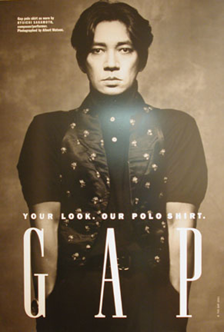 Gap poster showing Ryuichi Sakamoto in a dark polo shirt with a large Gap wordmark.