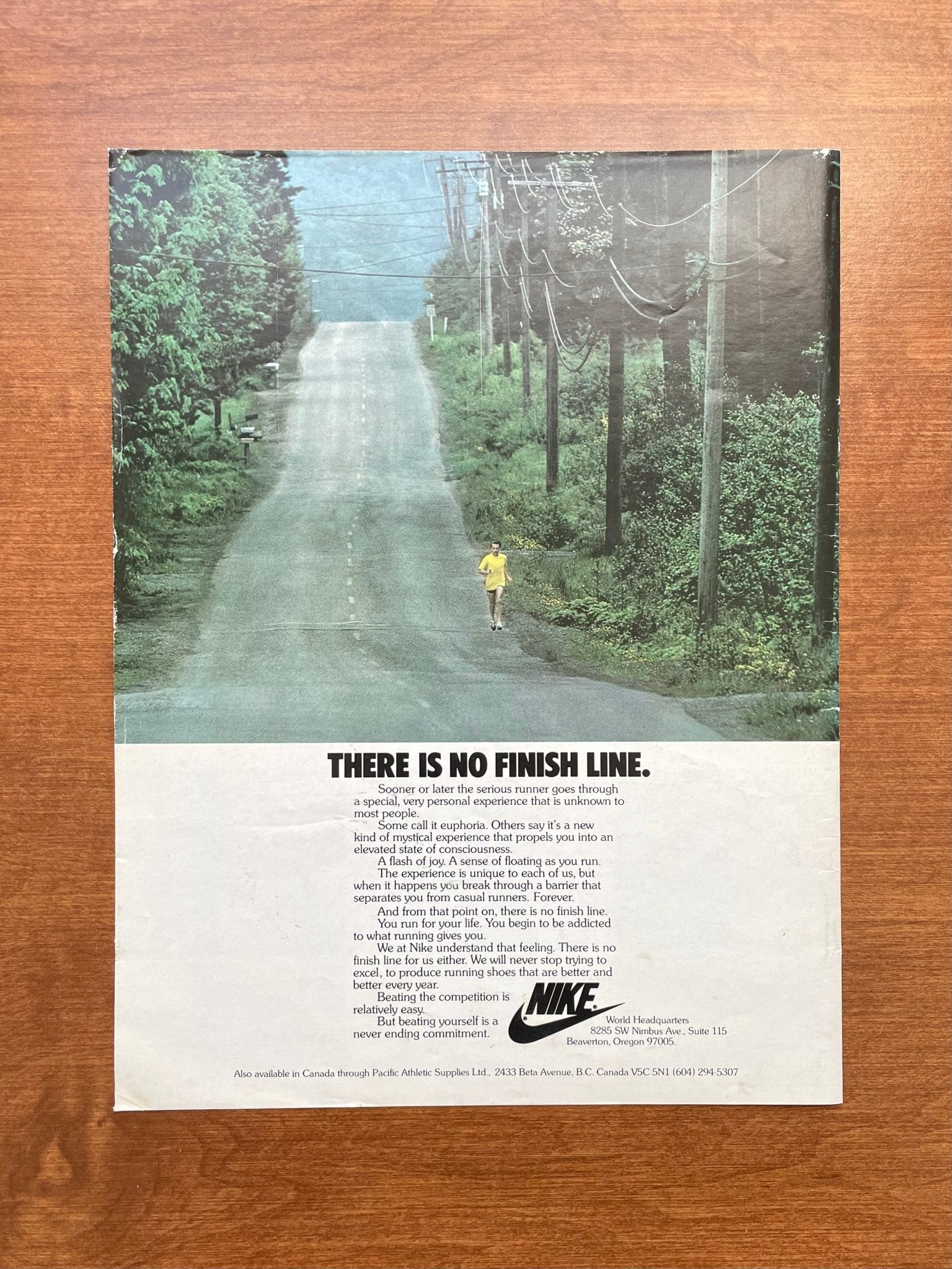 Photograph of the complete Nike There Is No Finish Line magazine page on a wooden surface, with readable body copy.