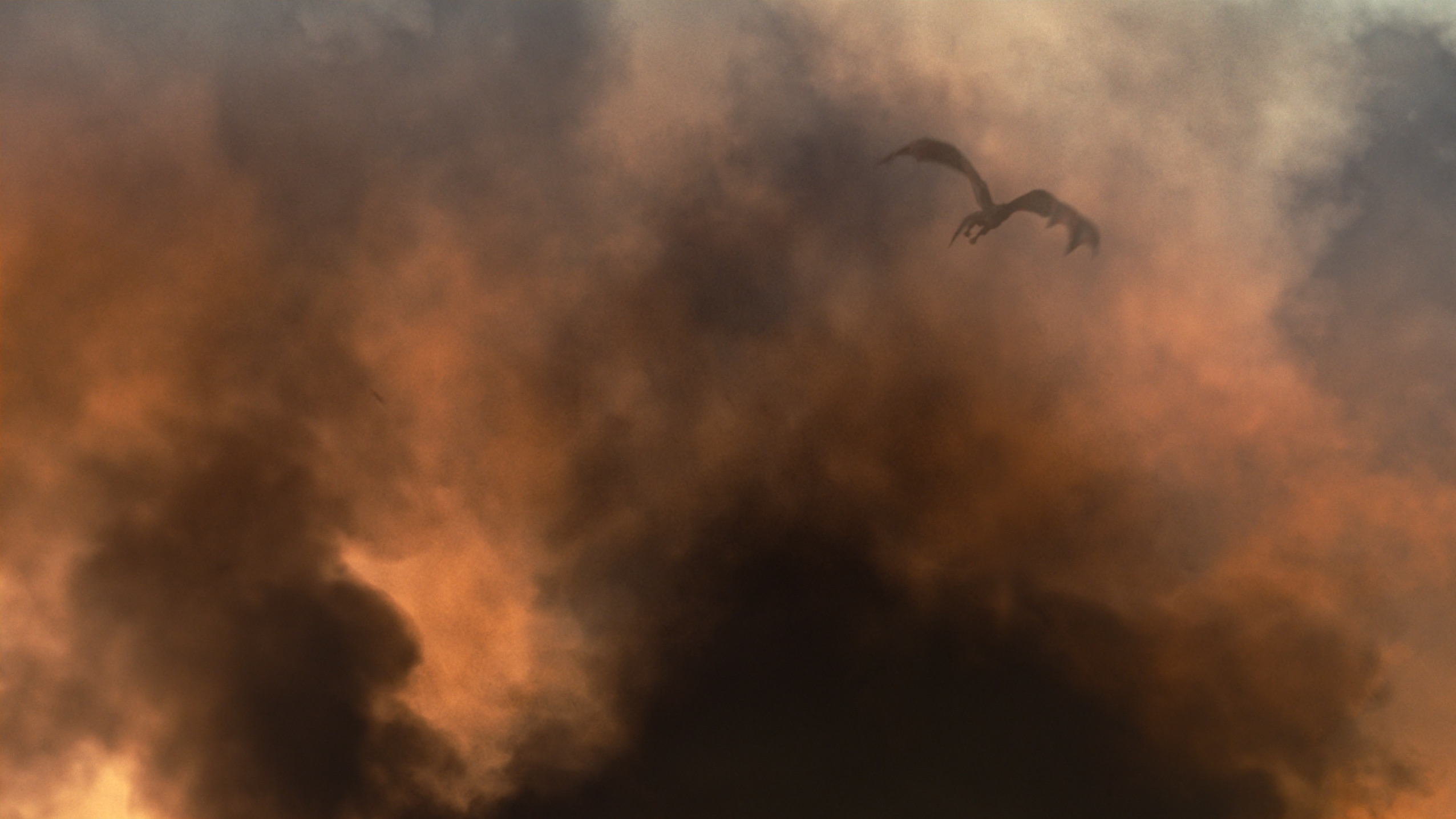 A dragon emerges through orange smoke after setting the jousting arena ablaze.