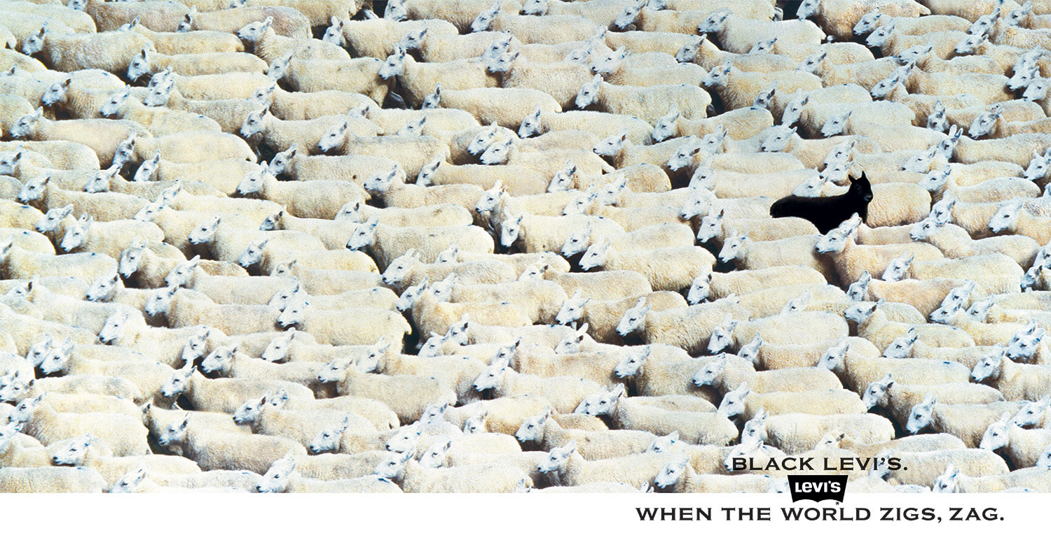 Complete Levi’s poster showing one black sheep facing away from a pale flock above the line When the world zigs, zag.