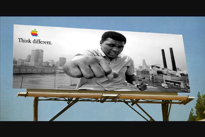 Muhammad Ali reaches a fist toward camera on an Apple Think Different billboard above the New York skyline.
