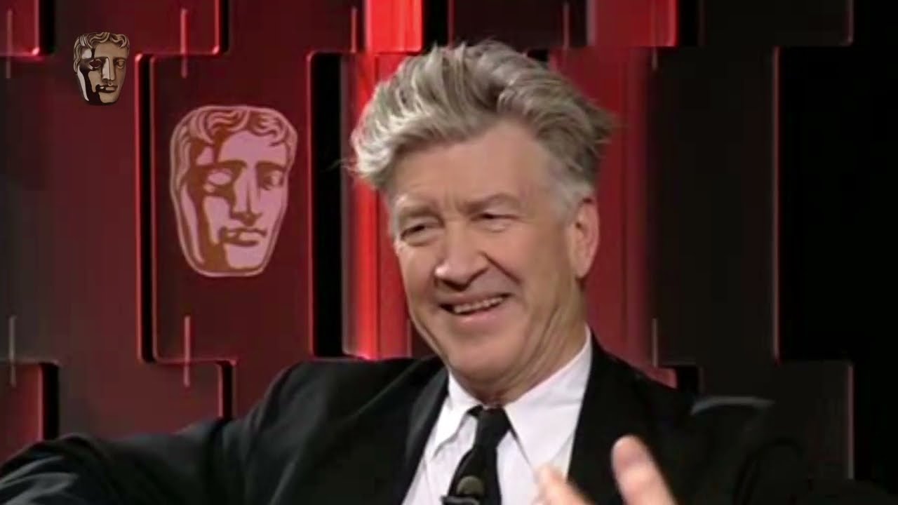David Lynch seated in front of a red BAFTA backdrop during the 2007 David Lean Lecture.